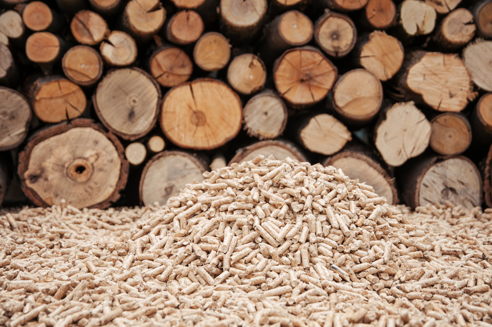 Pine pellets in front a wall of fire wood